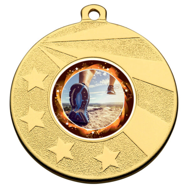 Bronze coloured golf medal featuring golf course landscape with dramatic sky in centre, surrounded by decorative star pattern border with atmospheric lighting effects