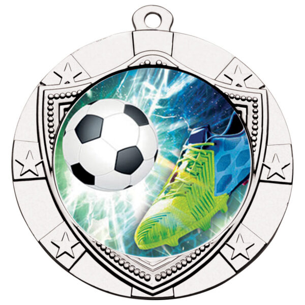 70mm silver-finished shield medal with decorative star border and central football design showing goalkeeper boot kicking ball with dynamic blue and green background effects