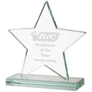 Five-pointed star-shaped clear glass award mounted on rectangular glass base, featuring BIC company logo engraving with 'Employee of the Year Wendy Jackson' text, photographed against white background