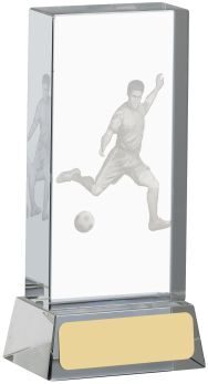 Rectangular clear glass block award with 3D laser engraved football player in kicking action pose, mounted on gold-coloured base with white engraving plate
