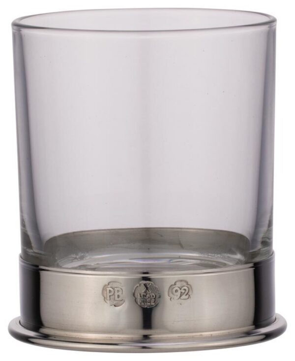 Clear crystal whiskey glass with polished pewter base showing traditional British hallmarks on white background