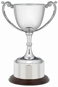 Premium nickel plated trophy cup with ornate scroll handles, polished finish, dark wooden base with metal band, and engraving area