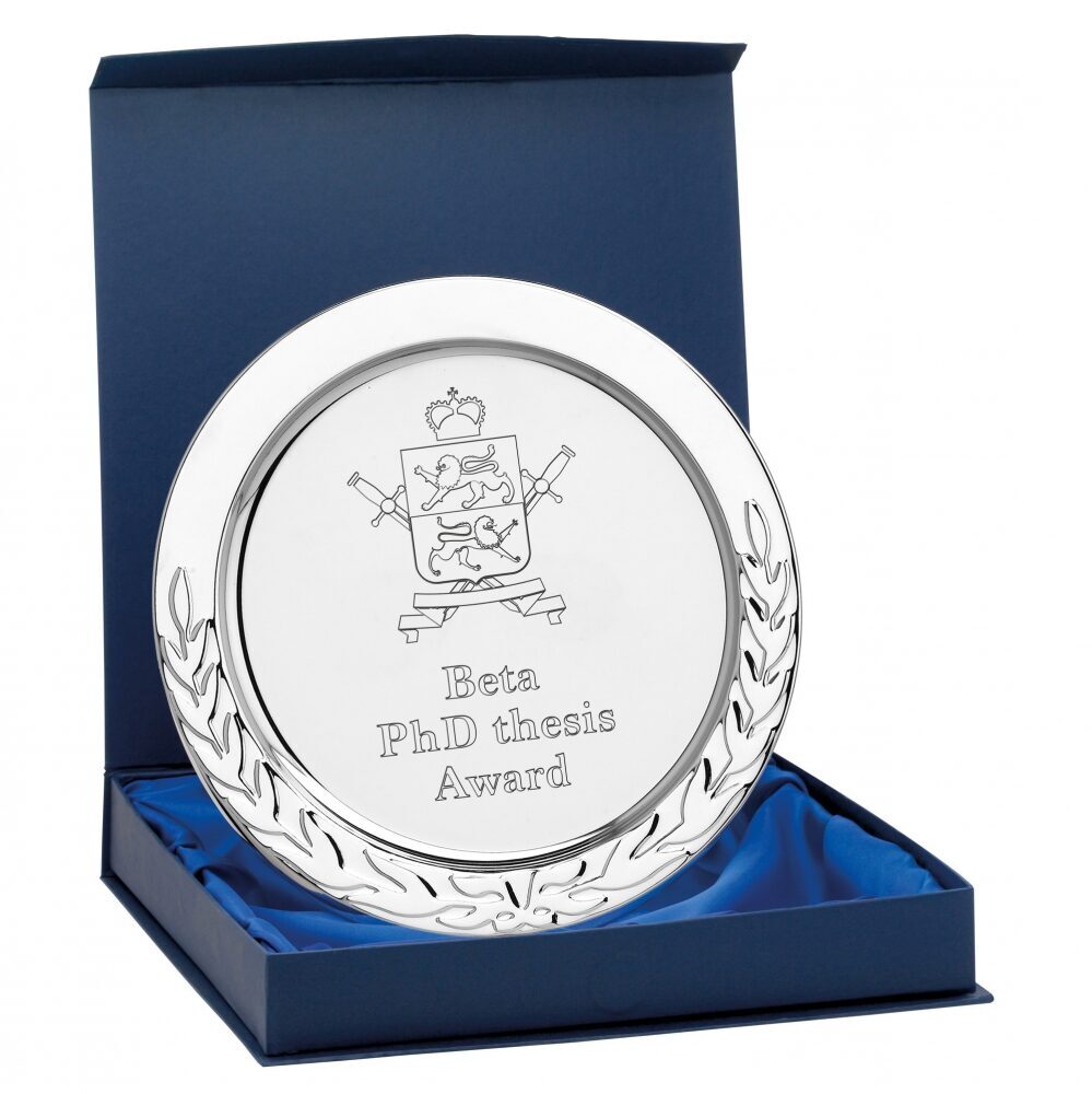 Silver plated presentation salver with decorative laurel leaf border sitting in navy blue presentation box with blue satin lining, showing mirror-like finish and engraving area