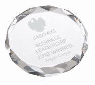 Round crystal paperweight with decorative faceted edge showing professional laser engraving, clear optical crystal with smooth finish for desktop display
