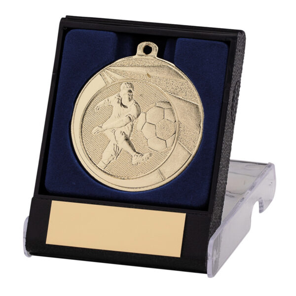 Gold football medal displayed in blue velvet-lined black presentation box with blank engraving plate, featuring detailed embossed design of football player with ball on clear acrylic stand