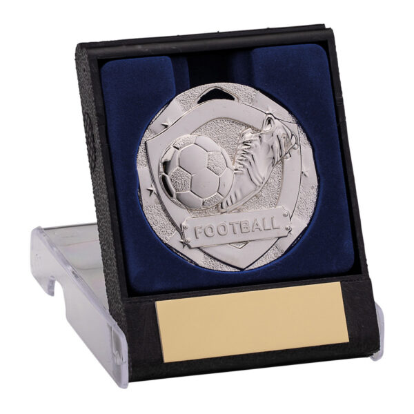 Silver football medal with boot and ball design in black presentation box with navy blue velvet lining and gold engraving plate on clear plastic stand