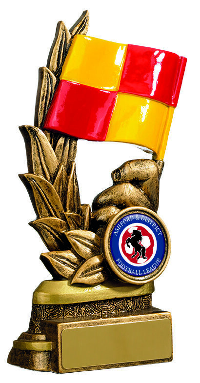 Antique gold linesman trophy with prominent red and yellow chequered offside flag, whistle detail, laurel wreath, club badge holder and engraving plaque