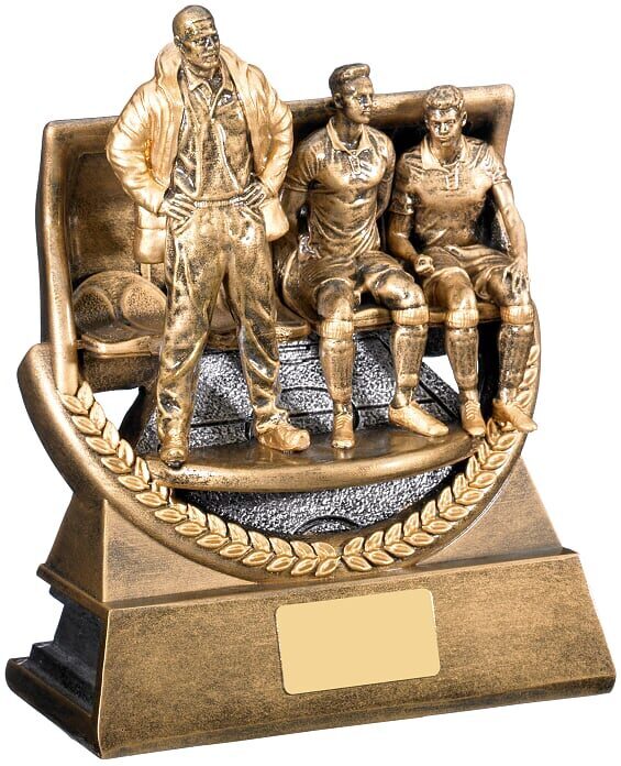 Bronze finished football manager award trophy showing standing coach with two seated players on decorative base with laurel wreath border and gold engraving plate