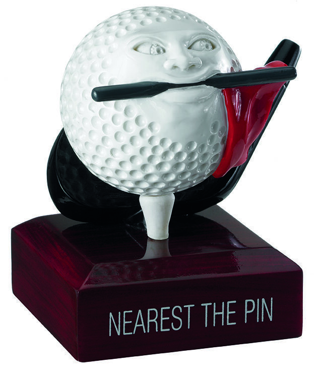 Comedy golf trophy featuring a white golf ball character with facial features and black smoking pipe, mounted on dark mahogany base with 'NEAREST THE PIN' text