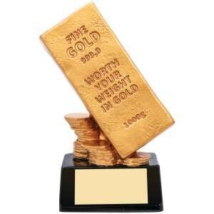 Golden novelty trophy shaped like a tilted gold bar with 'WORTH YOUR WEIGHT IN GOLD' text on black base with engraving plate