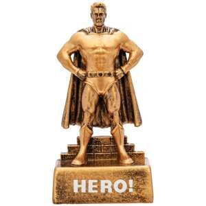 Golden bronze male superhero trophy showing muscular figure in cape standing heroically with hands on hips, mounted on base with HERO inscription and blank engraving plate