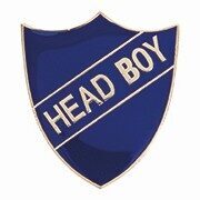 Blue shield-shaped enamel badge with white HEAD BOY text on diagonal banner, featuring secure pin fastening on reverse for school uniform wear