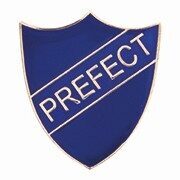 Blue prefect badge with classic shield shape featuring deep blue enamel background, refined gold-tone border and prominent raised gold lettering spelling PREFECT