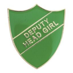 Green shield-shaped enamel pin badge with gold-coloured border featuring 'DEPUTY HEAD GIRL' text in gold letters on a diagonal banner across the green background