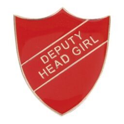 Red shield-shaped enamel badge with gold 'DEPUTY HEAD GIRL' text across a diagonal banner, featuring polished edges and pin back fastening