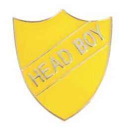 Yellow enamel shield-shaped pin badge with HEAD BOY text in silver lettering, featuring secure pin fastening for school prefect identification