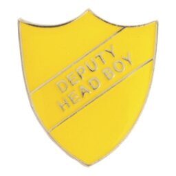 Yellow shield-shaped enamel school badge with embossed 'DEPUTY HEAD BOY' text in silver lettering, featuring polished metal edges and secure pin fastening