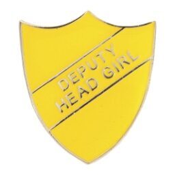 Yellow shield-shaped enamel school badge with 'DEPUTY HEAD GIRL' embossed in silver lettering, featuring polished metal edges and secure pin fastening mechanism